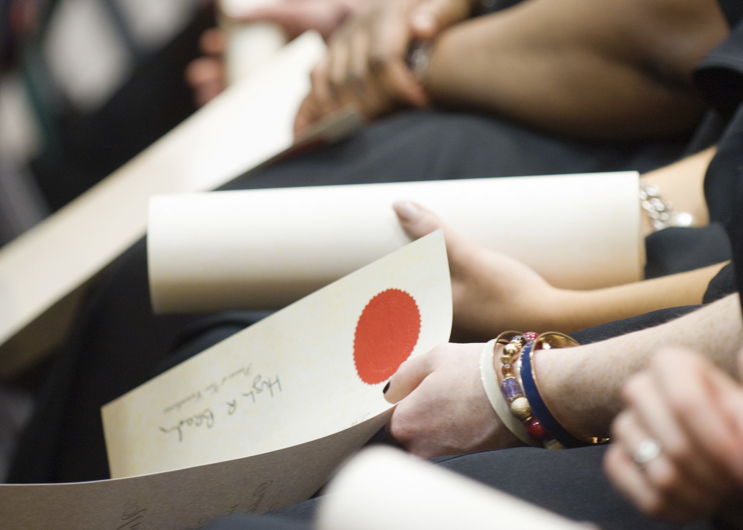 Students holding their conferring scroll