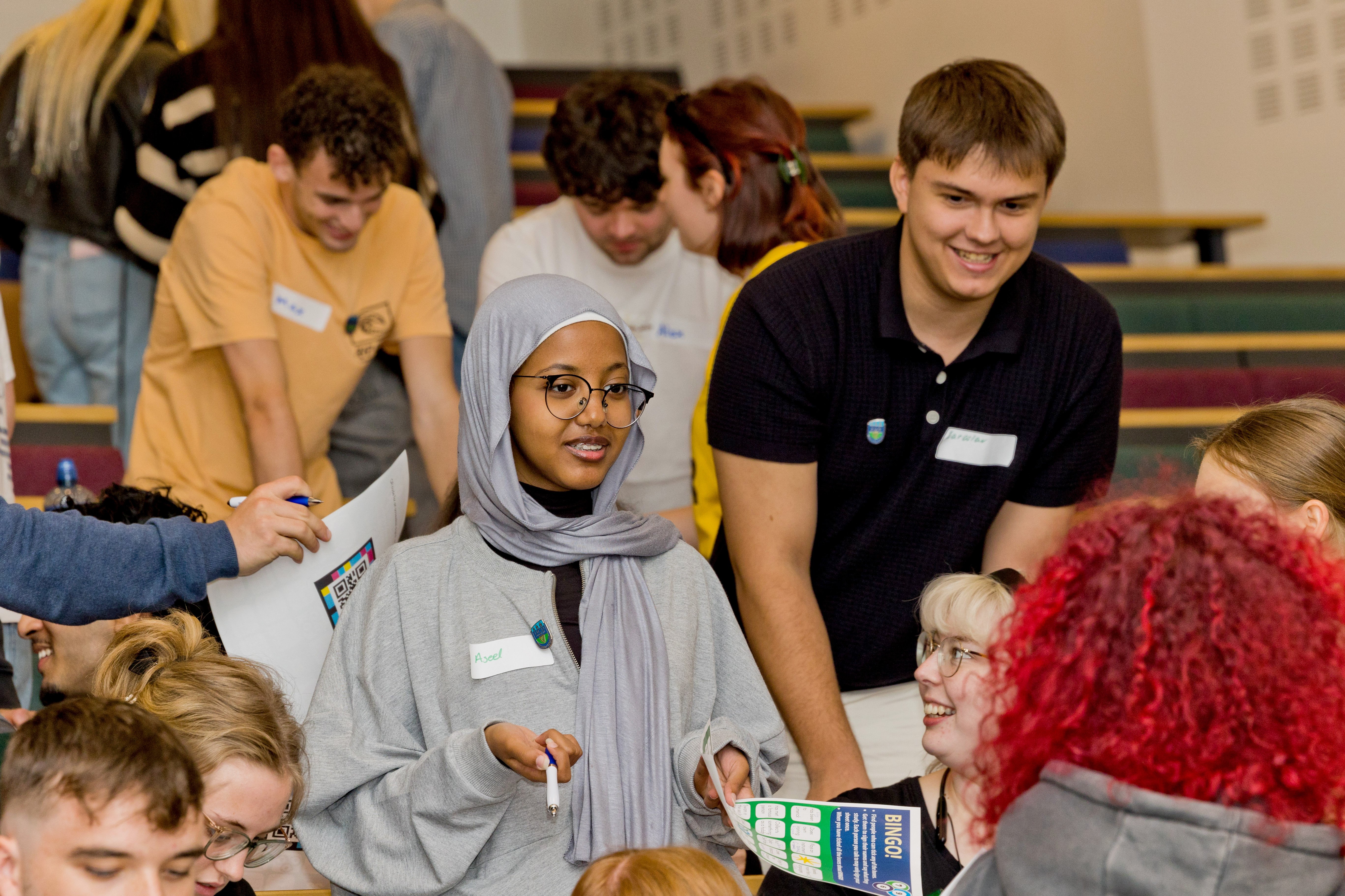 Smiling students taking part in the human bingo student welcome activity