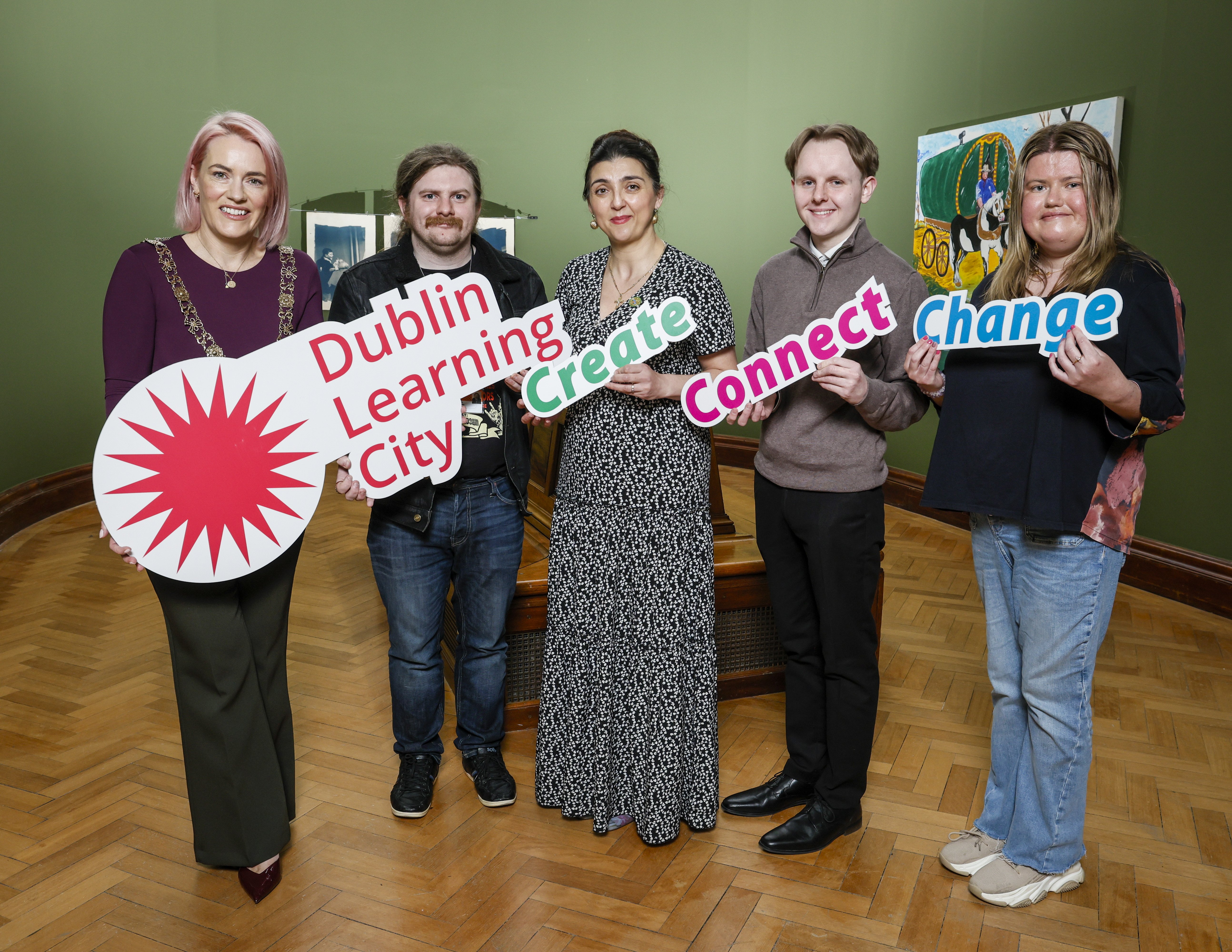 A group of 5 people holding the Dublin Learning City sign