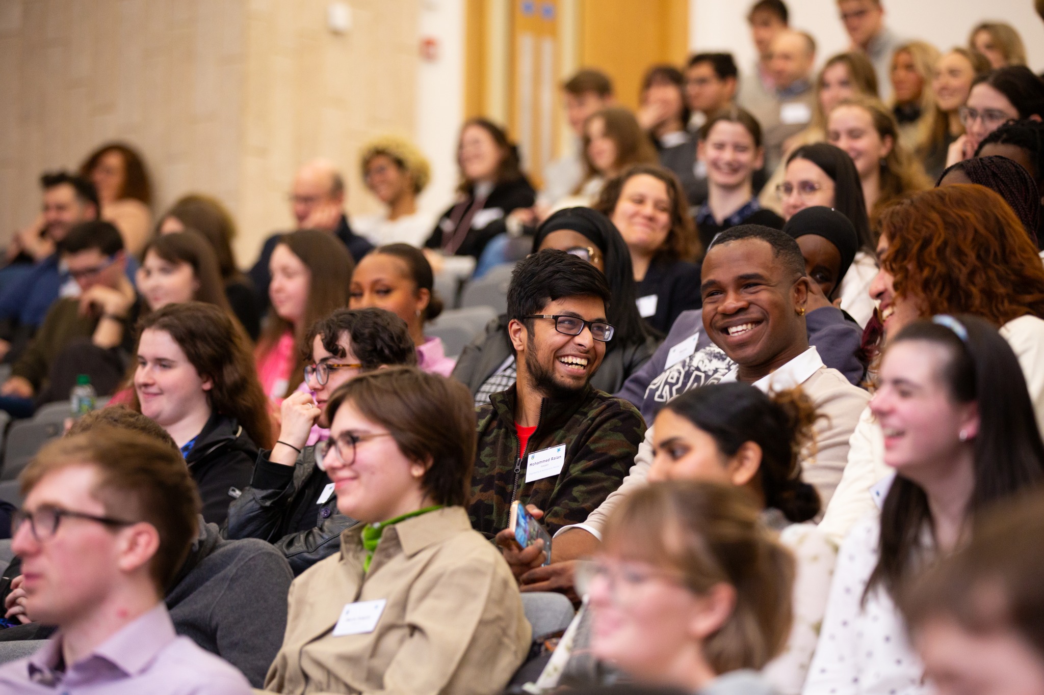 A full lecture theatre of smiling students and alumni at a UCD Career Mentoring Launch event.