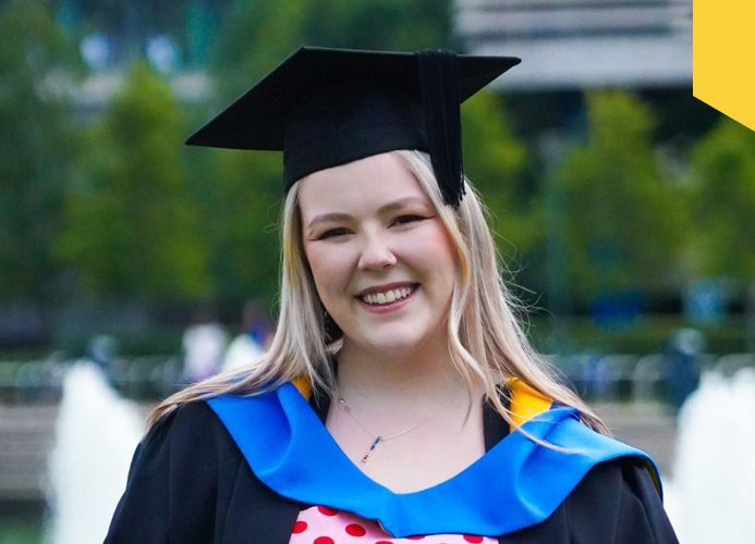 Niamh Scully, a new graduate of UCD in front of the main lake at Belfield