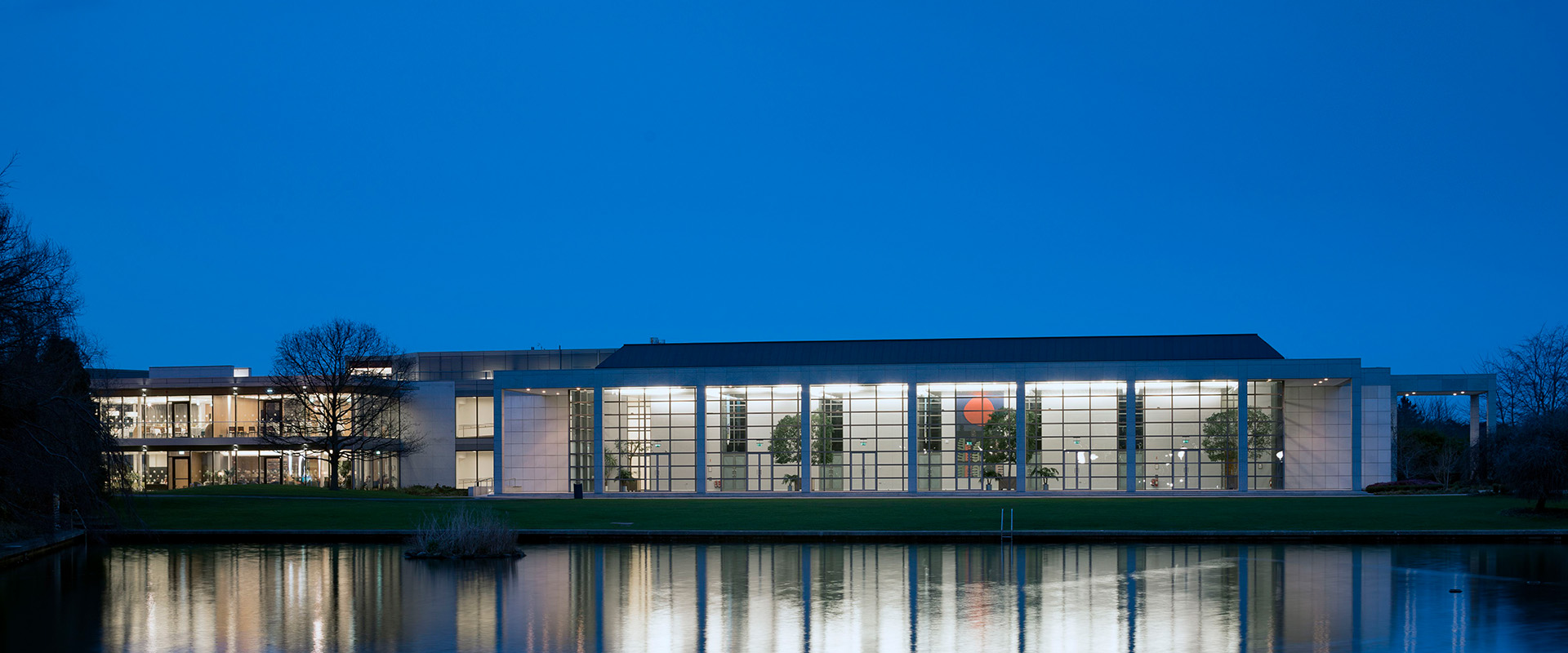 Night time view of O'Reilly Hall across the lake