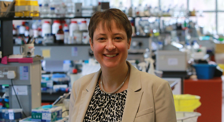 A woman smiling in the laboratory