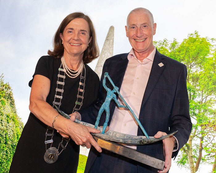 Woman presenting award to man