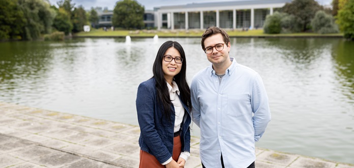 Woman and man smiling with lake in background