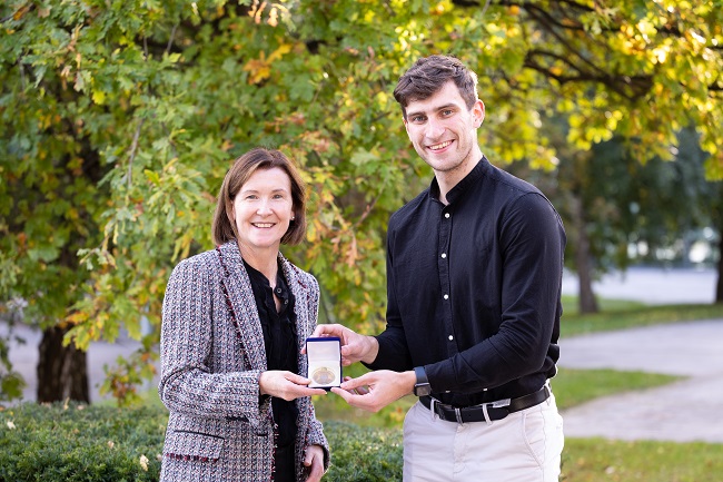 Two people smiling at award presentation