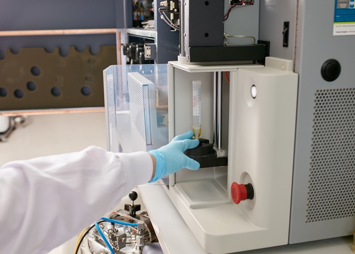 Gloved hands working a machine