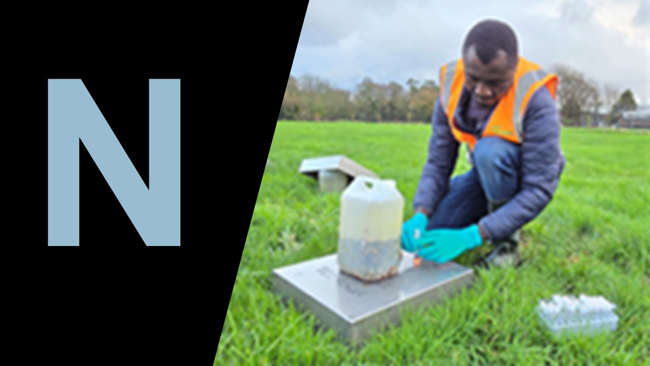 Man carrying out experiment in a field, large capital N