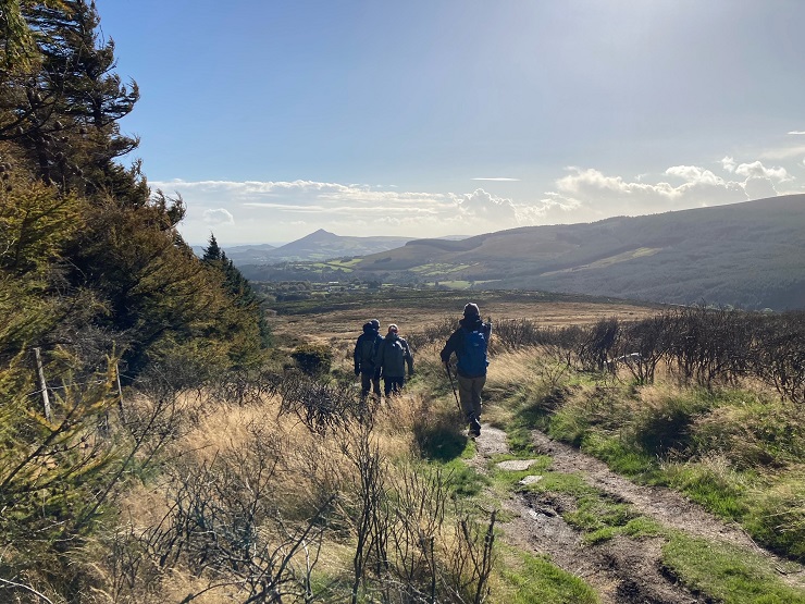 People on a pathway in mountain landscape