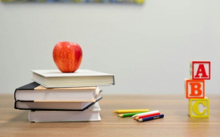 Pile of books with apple on top