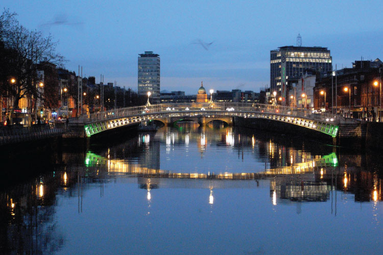 Dublin's Hapenny Bridge and River Liffey at night