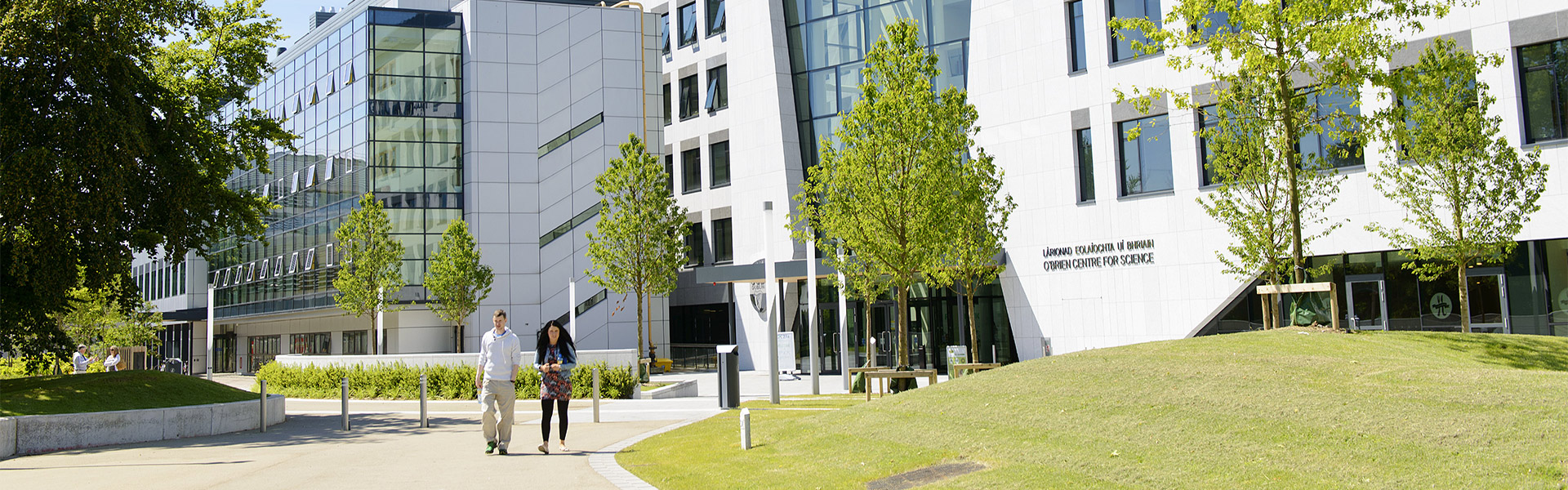 Two students walking outside the UCD Science Building.
