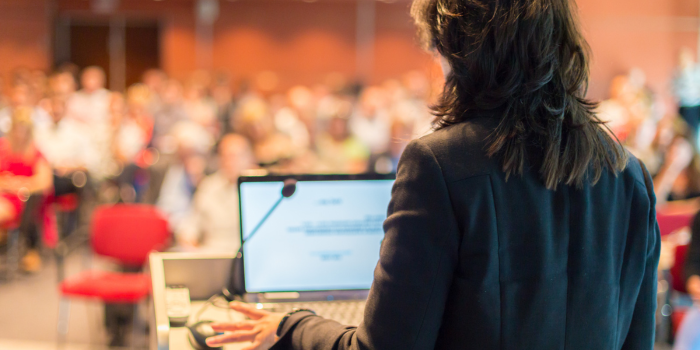 image of speaker at conference