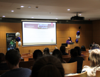 People sitting in lecturer theatre watching talk on International Women's Day 2024