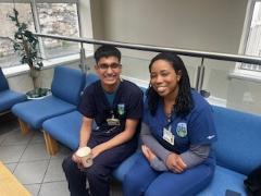 Students in scrubs sitting on blue sofa