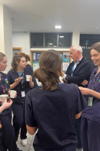 SVUH staff and students at coffee morning standing