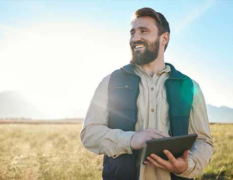 Man smiling out in a field.