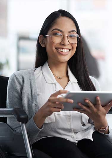 Woman in a wheelchair holding a tablet.