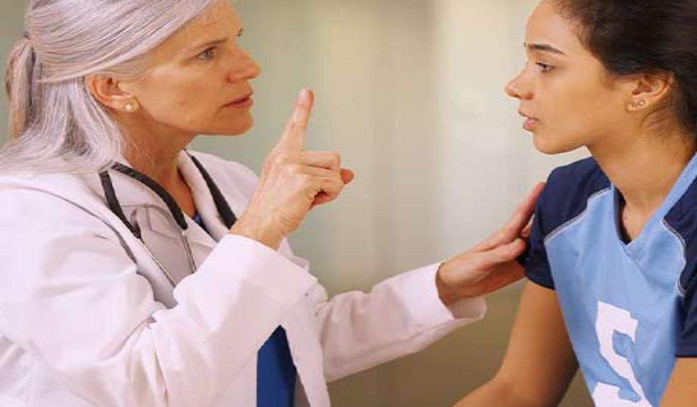 Doctor examines a girl with a head injury.