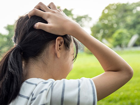 Girl Holds her Head