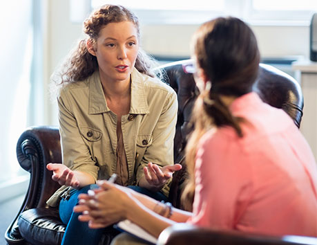 Two women speaking.