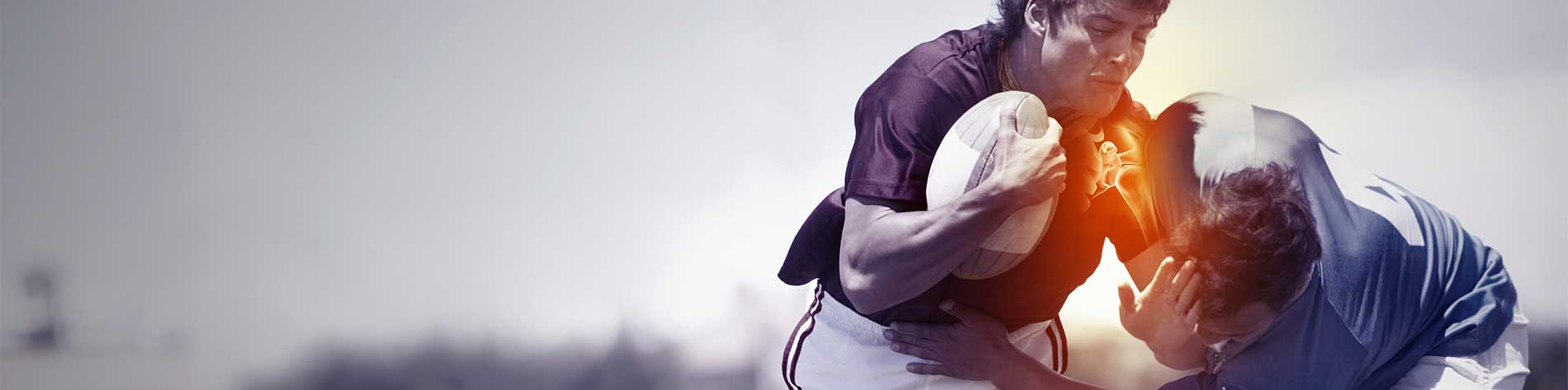 Two men clash in a game of rugby. One man has a glowing red shoulder to indicate pain.