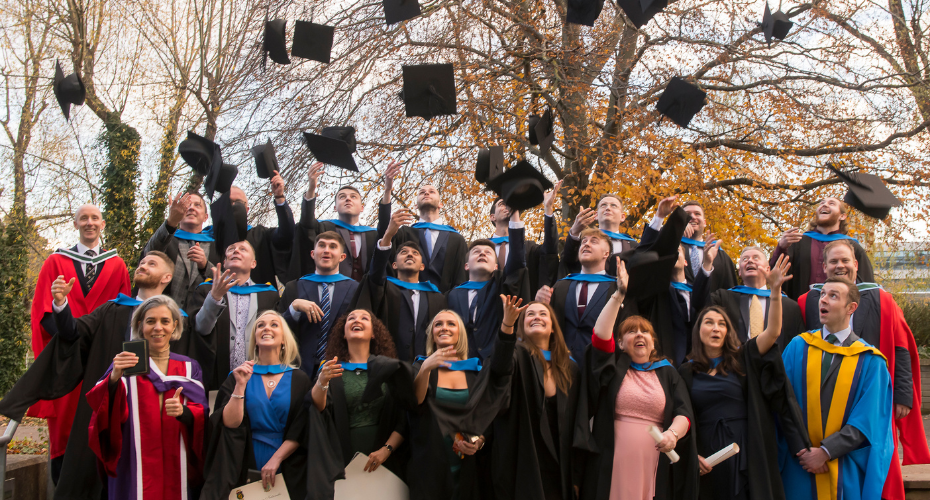 Graduating class throwing caps