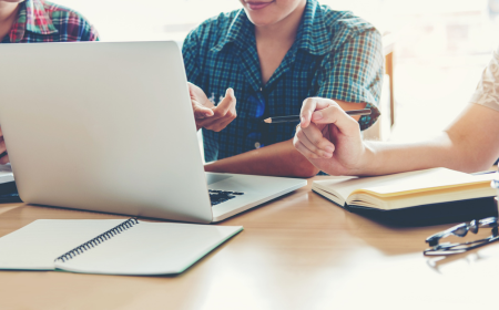 Group of researchers working at a laptop