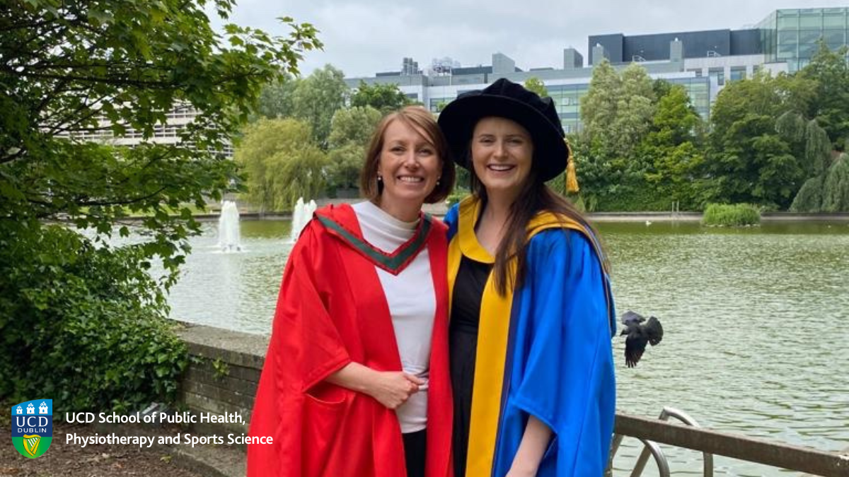 Academic with PhD graduate in front of lake