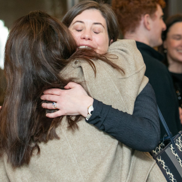 Two people hugging at the UCD Physiotherapy 70th anniversary celebration