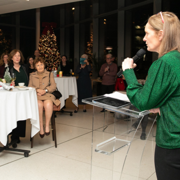 Woman in green top speaking at the UCD Physiotherapy 70th anniversary celebration