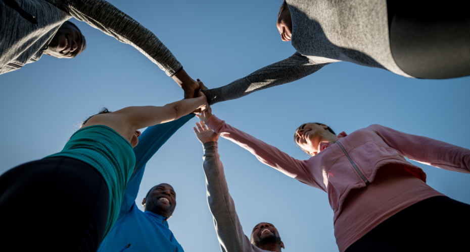 Group of athletes joining hands