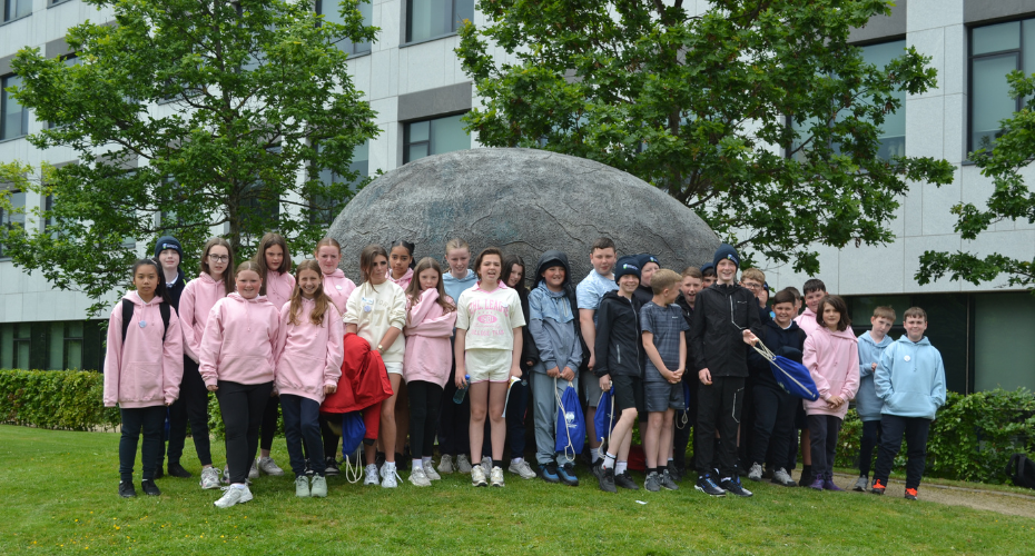 Group of school students standing in front of sculpture at UCD