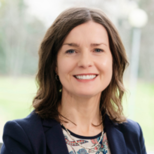 Woman with dark hair smiling to camera