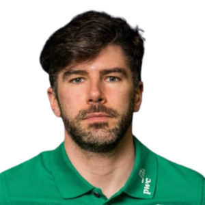 Man with dark hair and beard wearing a green shirt