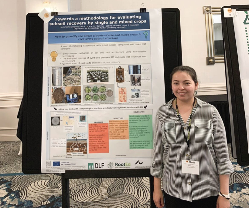 A woman standing at a poster