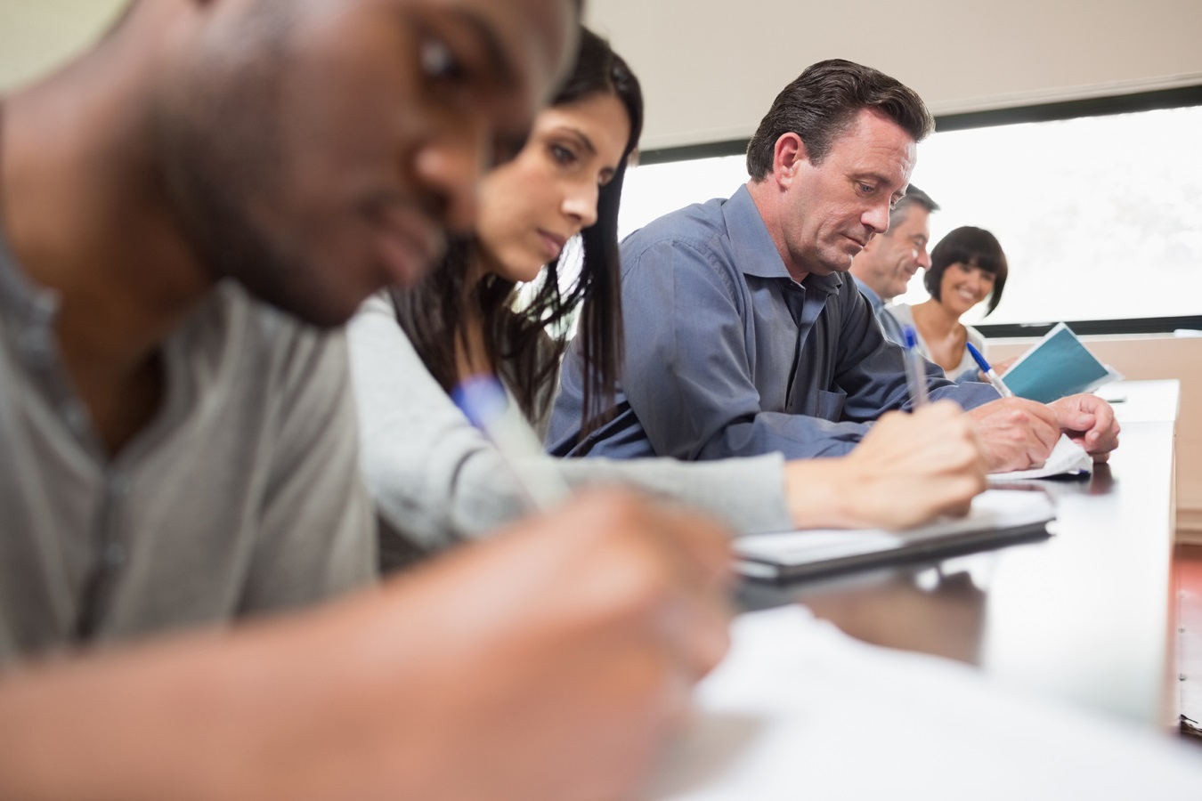 students-writing at desk