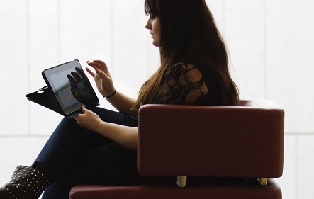 A student sitting with an ipad