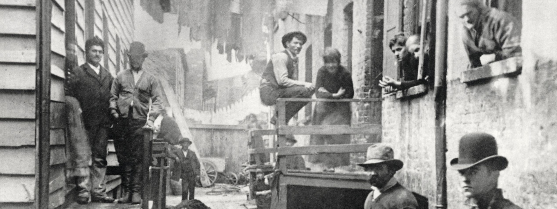 black and white picture of alleyway with dodgy looking fellas left and right