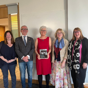 Phyllis holding her book in group shot