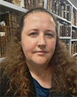 a female staff member in front of books