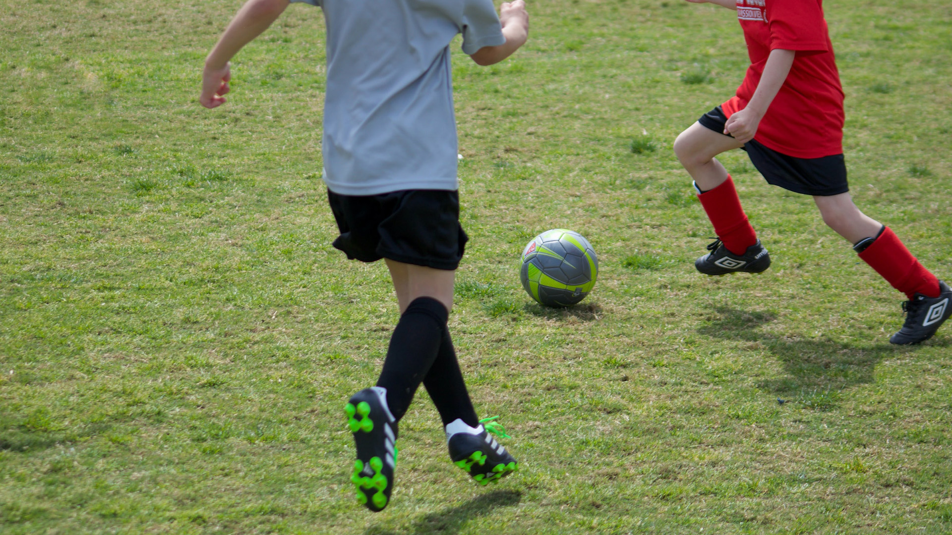 Kids playing soccer on grass