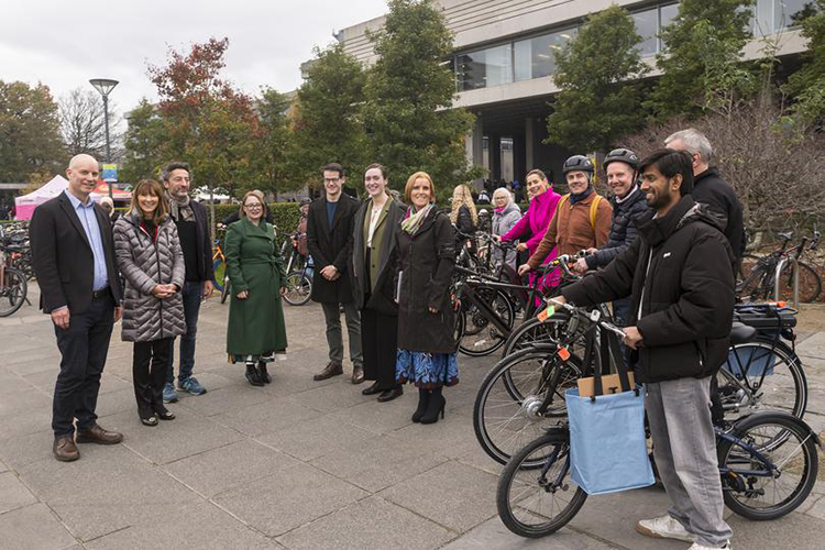 UCD Bike Library launch showing people with bikes at UCD Belfield next to the main lake