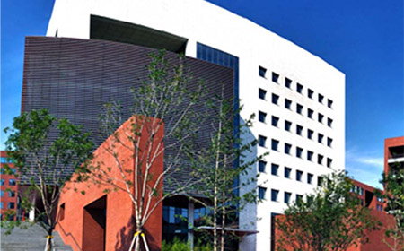 A white and red building with trees outside.