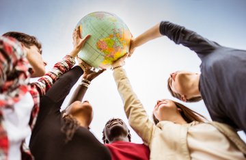 Student holding a globe