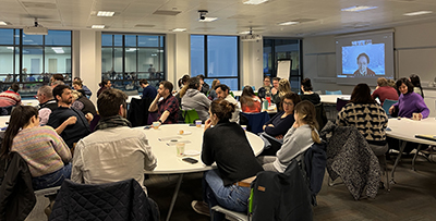 Groups of participants seated around tables at the School's sustainability workshop