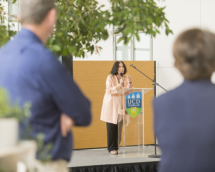 Professor Cecily Kelleher speaking to Vet School staff and guests from a UCD podium