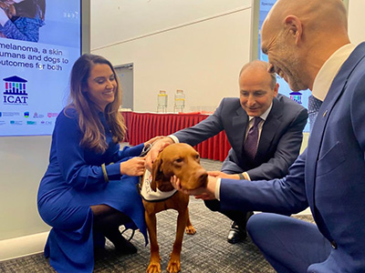 Dr Stephanie Bollard, An Taoiseach Micheál Martin and Professor Conall Dennedy with Apollo the dog