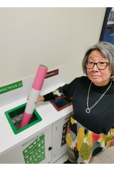 Dr Mary Sekiya placing an item in a recycling bin