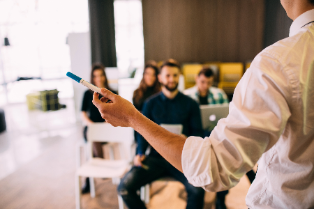 Training session with speaker standing in front of seated colleagues